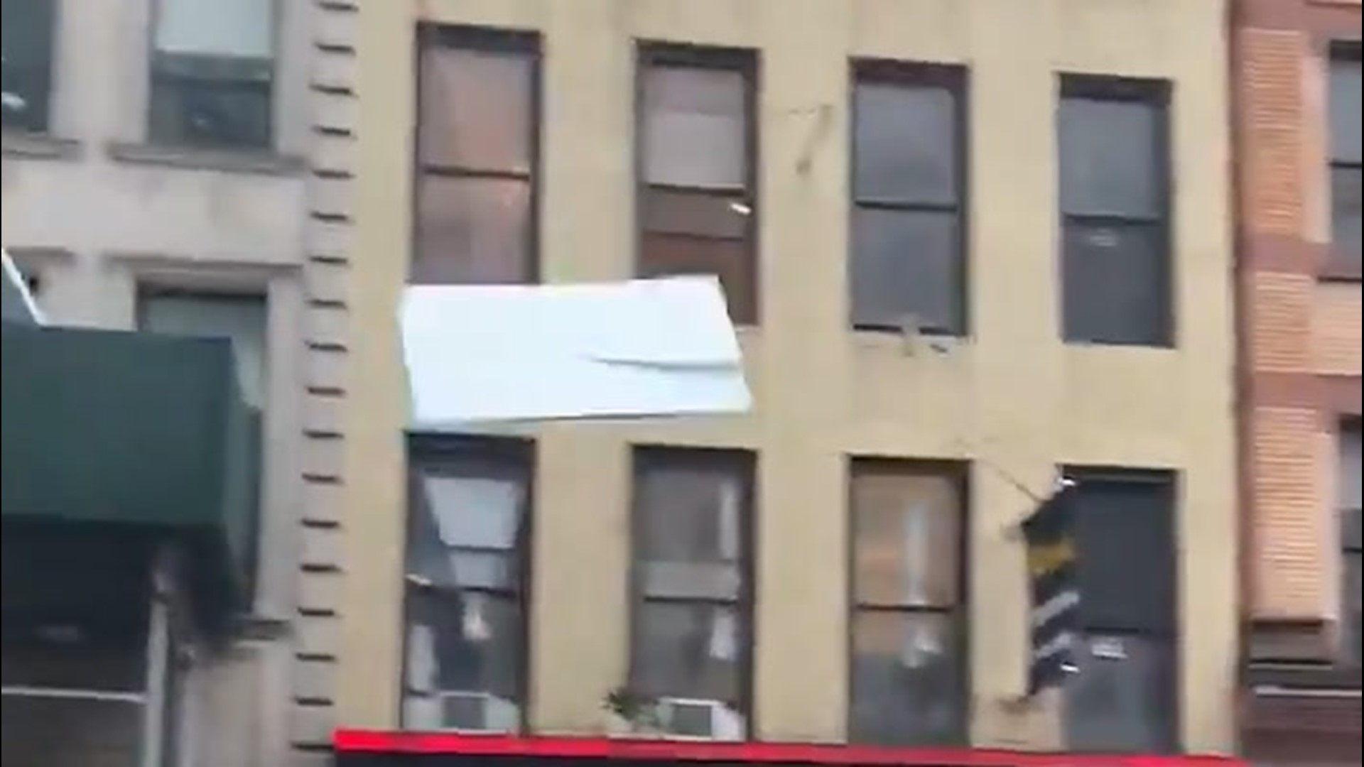 Isaias' winds sent debris flying like missiles through the streets of New York City on Aug. 4. It narrowly missed this moving car with bystanders frightened.