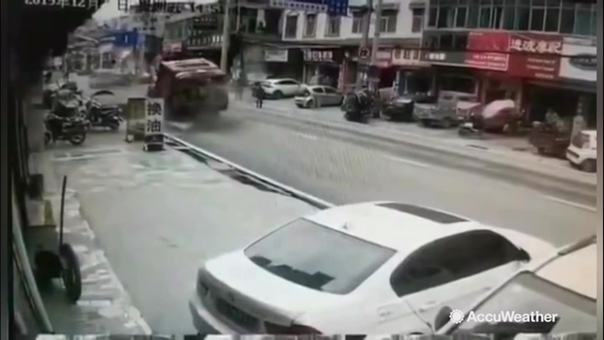 A truck driving along a street in Enshi, China,  was in the wrong place, at the wrong time on Dec. 27, when a massive sinkhole opened up underneath it, swallowing the truck.