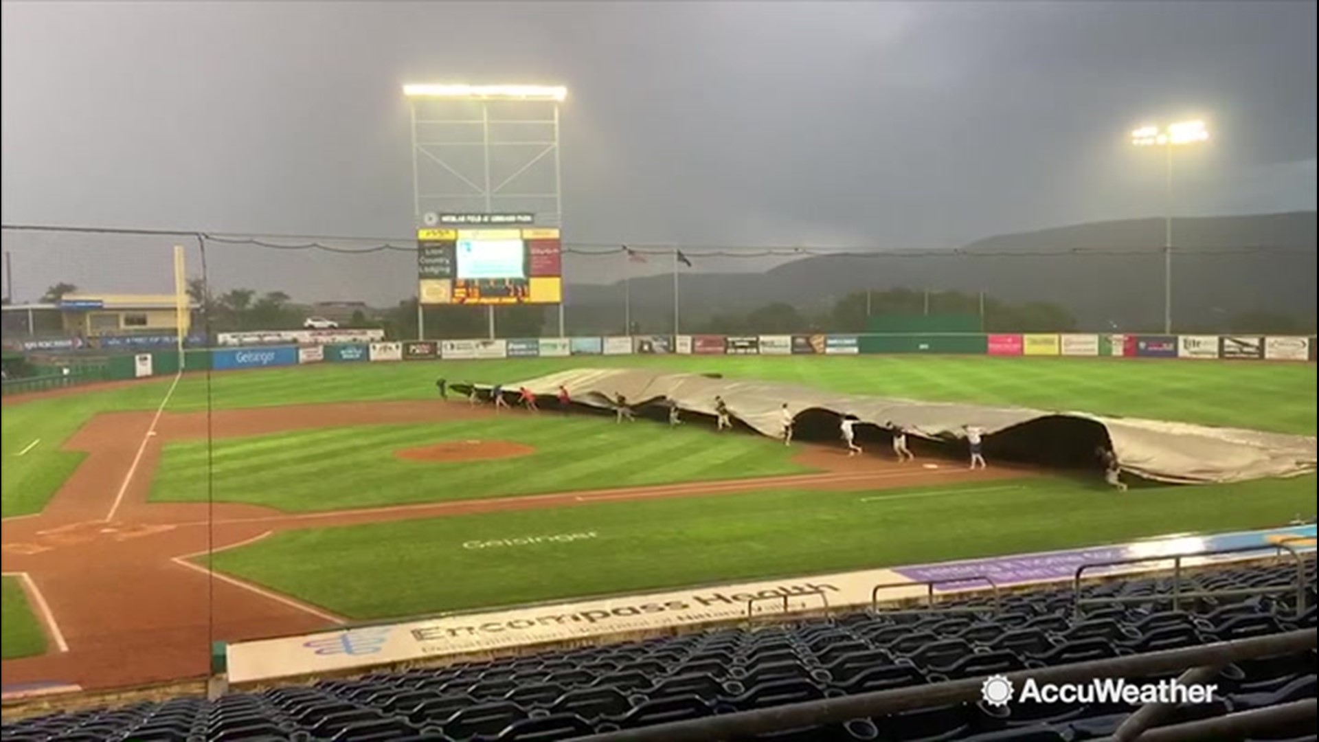 In this video, we sped up the staff at the Medlar Field at Lubrano Park, home of the State College Spikes, in the process of covering the field with a huge tarp to protect it from the rain as a storm intrudes on the game in State College, Pennsylvania, on Aug. 14.