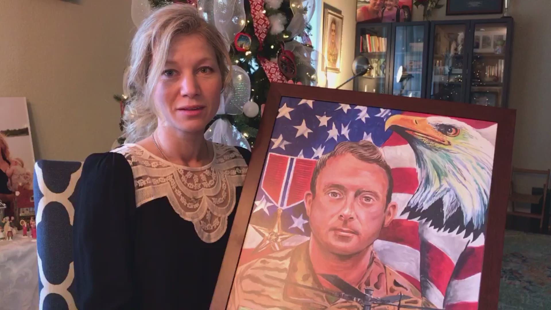 Widow of Fort Hood pilot, Silkey Knadle, receives a painting from Ken Pridgeon, who promised to paint portraits of every Texas service member in Iraq and Afghanistan