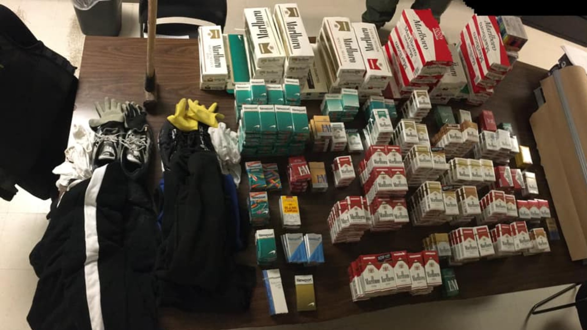 The two men were arrested Saturday after police found two trash bags filled with packs of cigarettes in a vehicle that was pulled over for speeding.