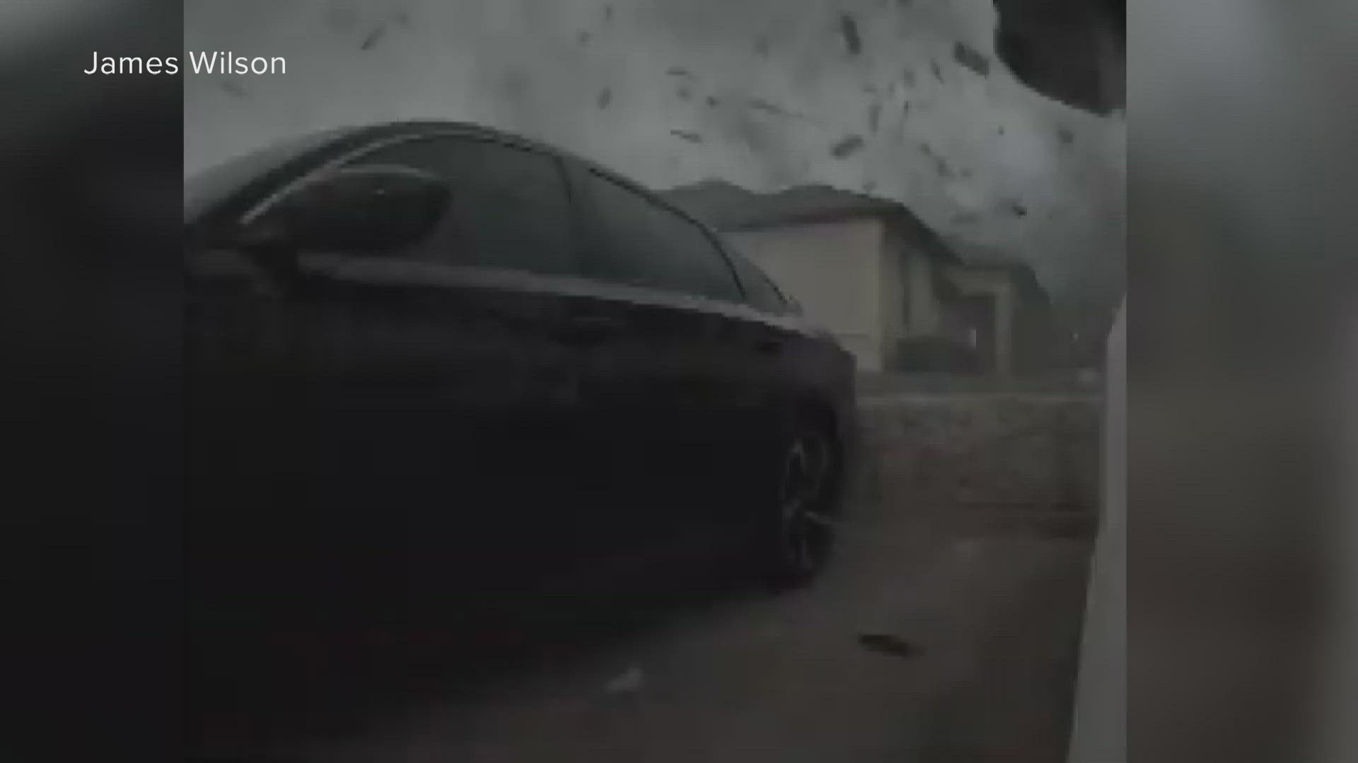 Video shows strong winds from the twister pick up debris from surrounding buildings, vehicles and plants before tossing them around.