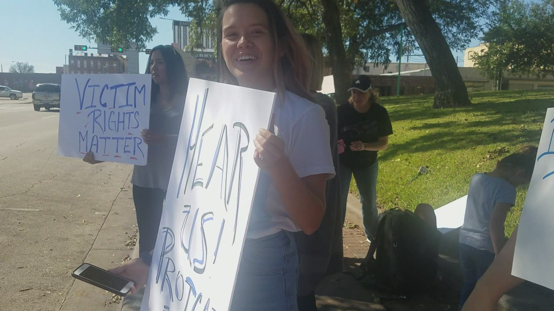 More than a dozen people lined the street outside the McLennan County Courthouse Friday in protest of a plea deal given to a former Baylor University fraternity member who was charged with rape.