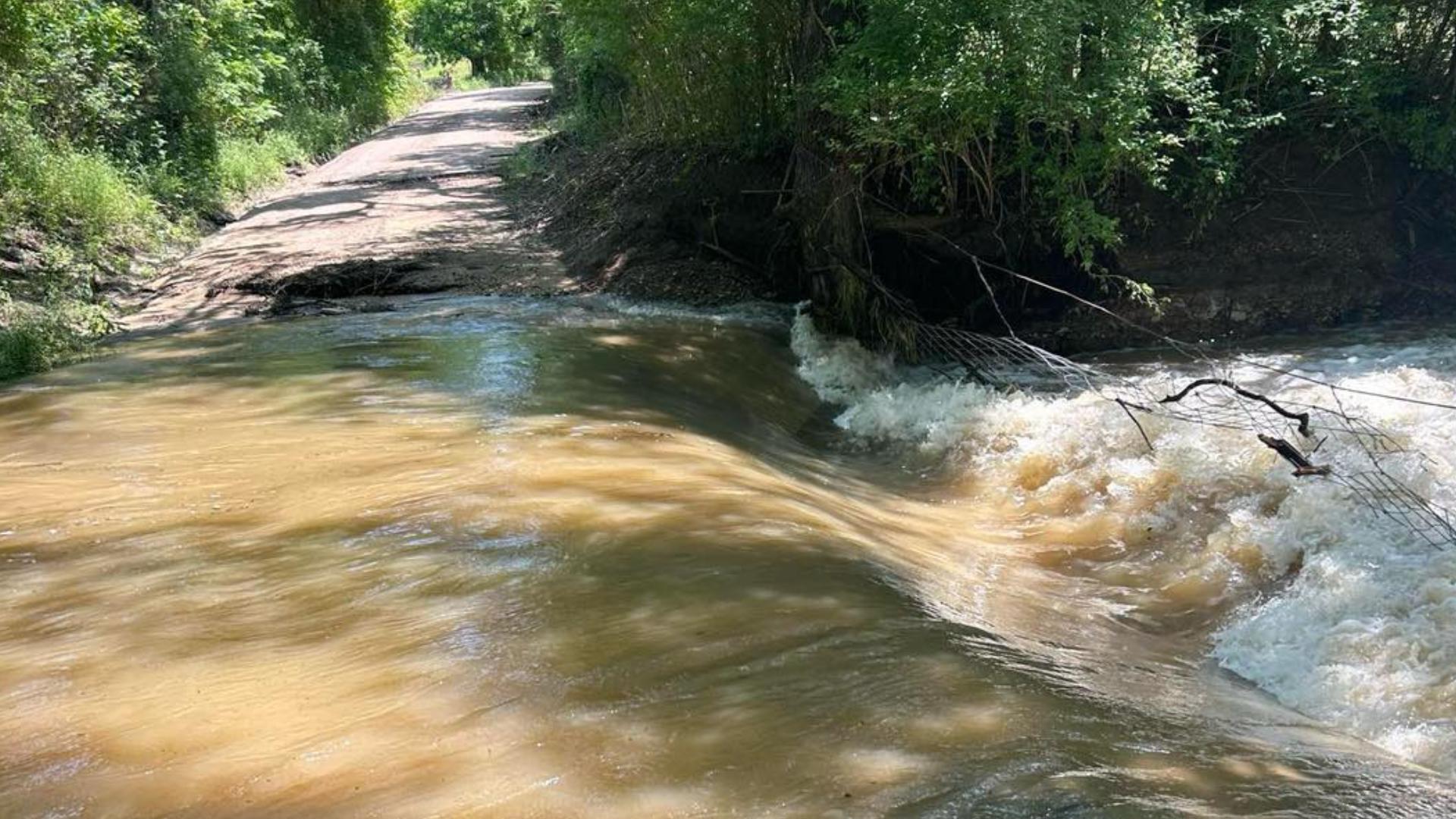 Flooding overtakes car on County Road 318.