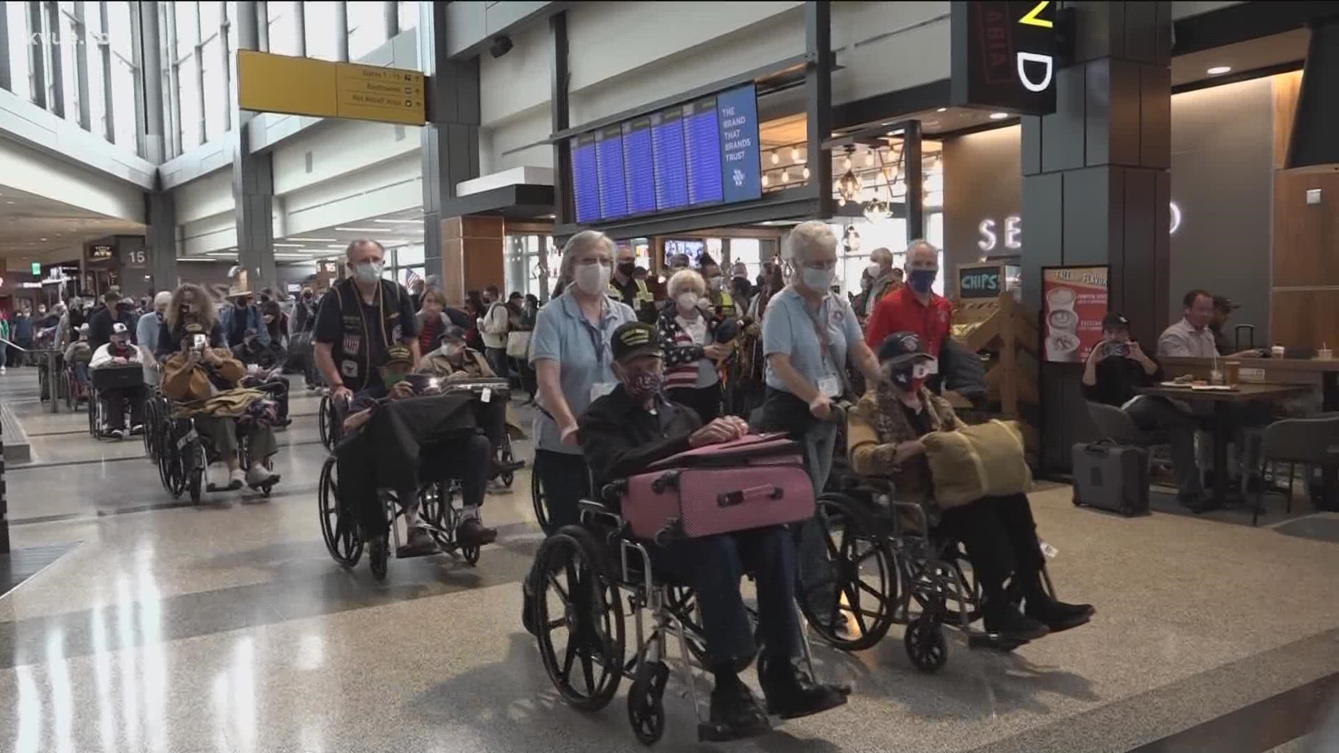 A sea of U.S. flags greeted WWII veterans at Austin-Bergstrom International Airport on Monday.