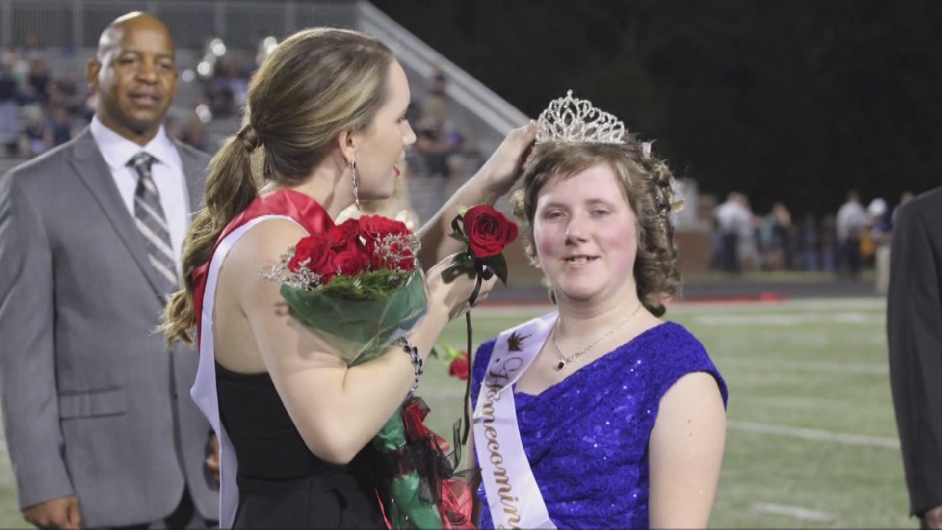 queen gives crown to classmate