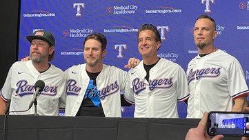 Creed band members at ALCS Game 3 in Texas Rangers gear