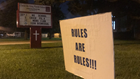 ‘Rules are Rules’ signs appear outside school at center of ‘hair-braid extension’ controversy